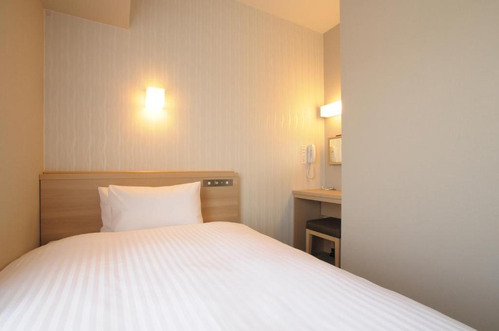 Letto o letti in una camera di AB Hotel Tahara