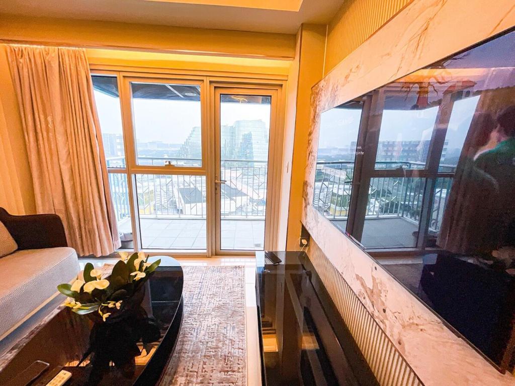 a living room with a couch and a large window at Ultra Luxury 1BR near Solaire & Okada in Manila
