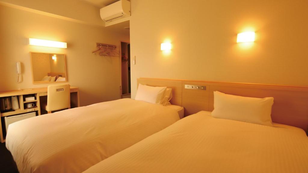 Postel nebo postele na pokoji v ubytování AB Hotel Gamagori