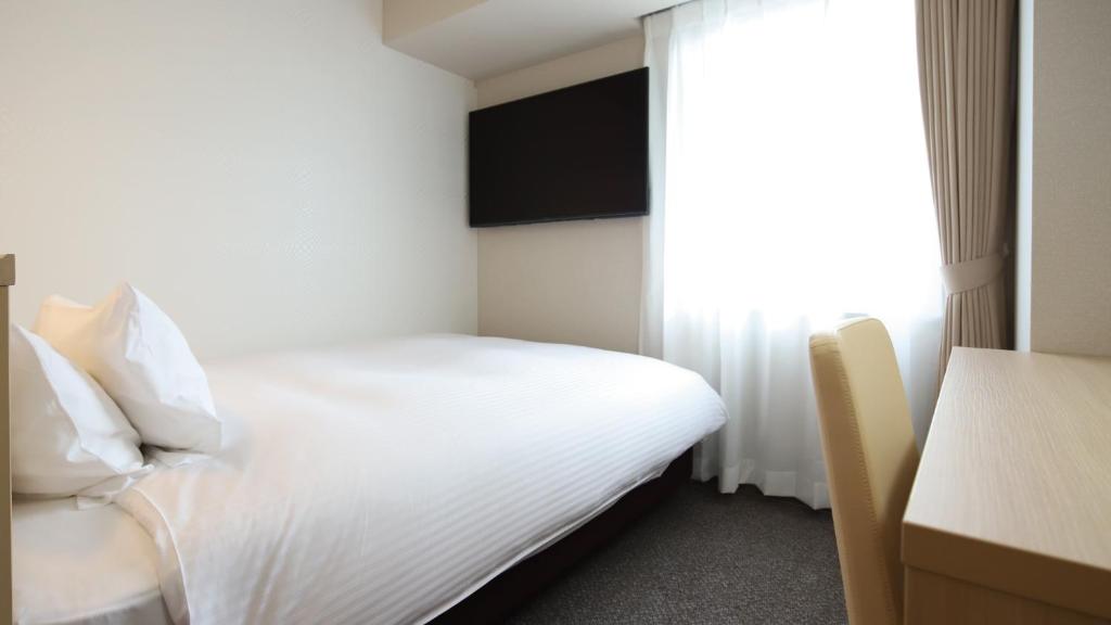 Postel nebo postele na pokoji v ubytování AB Hotel Shiojiri