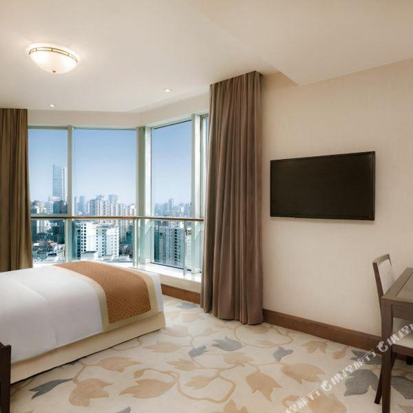 TV a/nebo společenská místnost v ubytování Shanghai Metropark Jichen Hotel