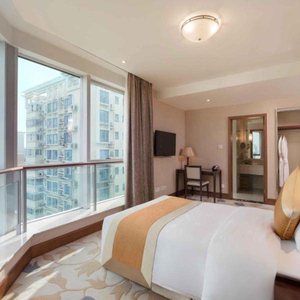 Postel nebo postele na pokoji v ubytování Shanghai Metropark Jichen Hotel