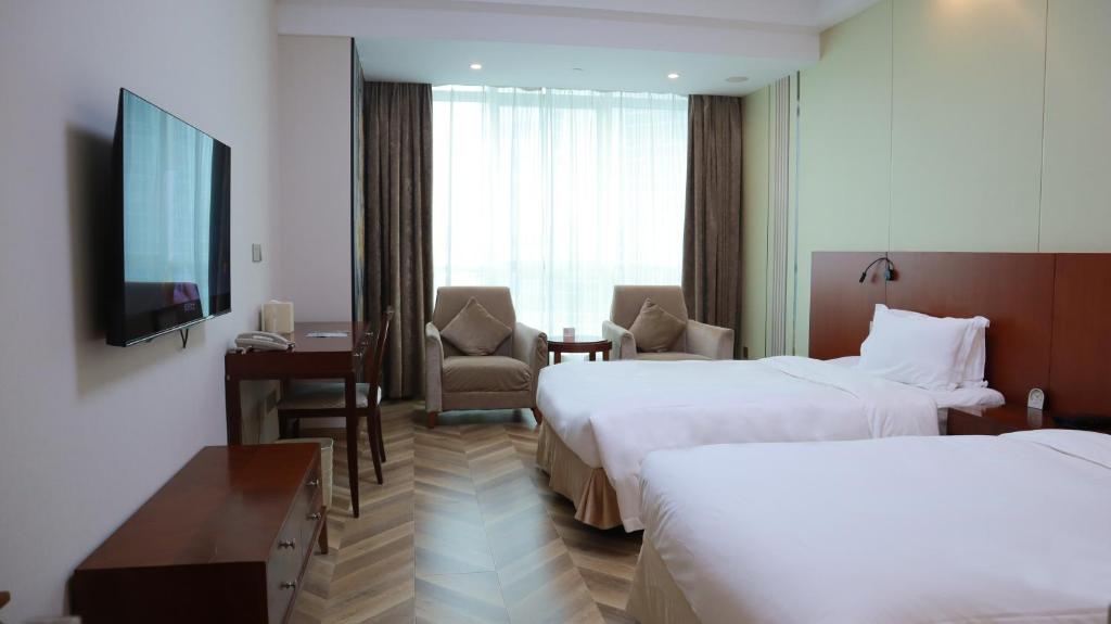 TV a/nebo společenská místnost v ubytování Shanghai Metropark Jichen Hotel