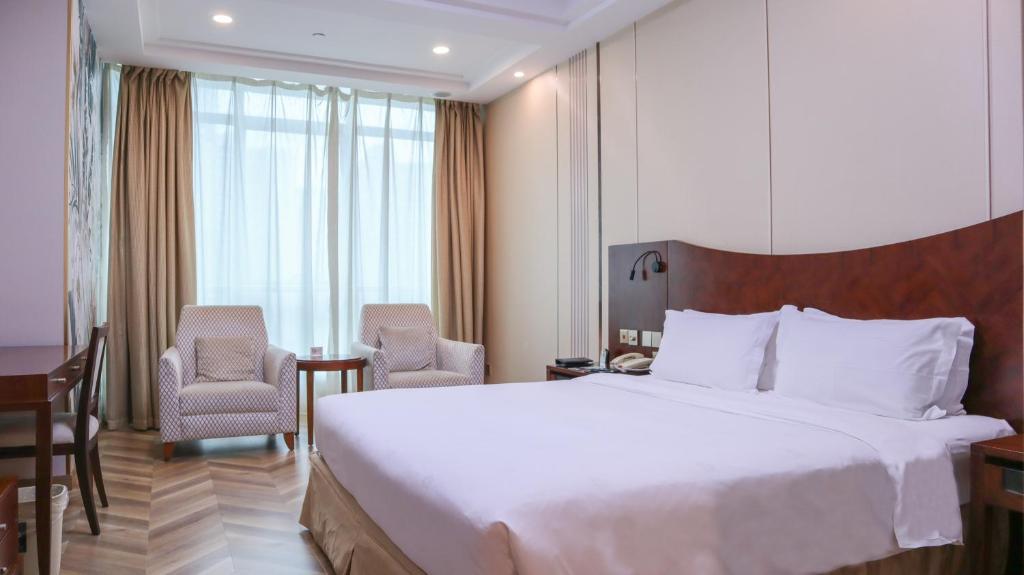 Postel nebo postele na pokoji v ubytování Shanghai Metropark Jichen Hotel