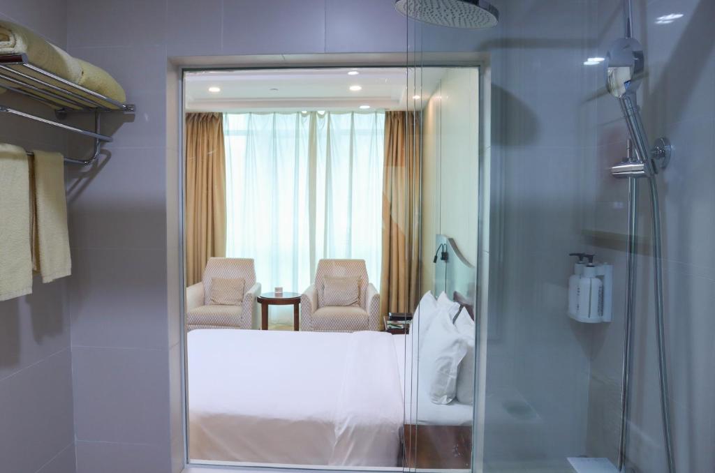 Postel nebo postele na pokoji v ubytování Shanghai Metropark Jichen Hotel