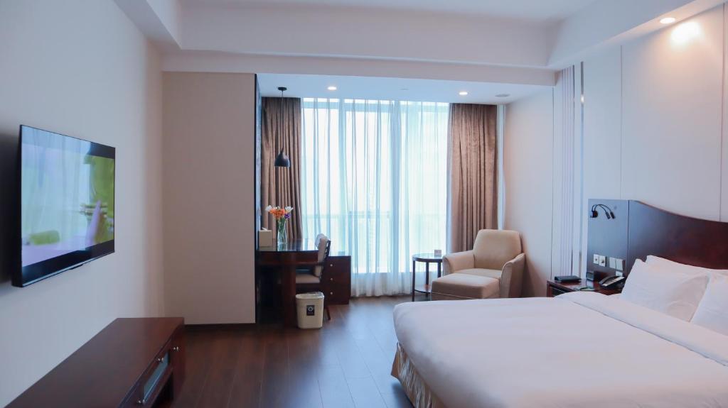 Postel nebo postele na pokoji v ubytování Shanghai Metropark Jichen Hotel