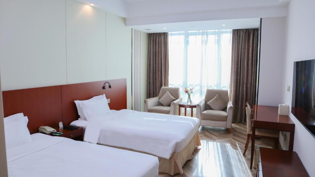 Postel nebo postele na pokoji v ubytování Shanghai Metropark Jichen Hotel