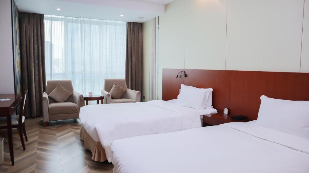 Postel nebo postele na pokoji v ubytování Shanghai Metropark Jichen Hotel