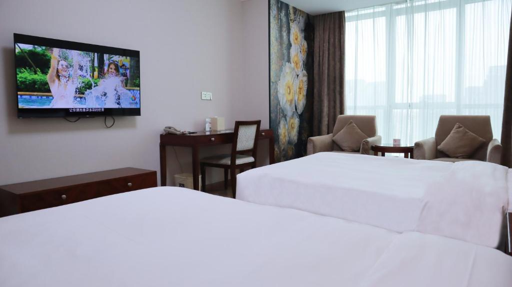 TV a/nebo společenská místnost v ubytování Shanghai Metropark Jichen Hotel