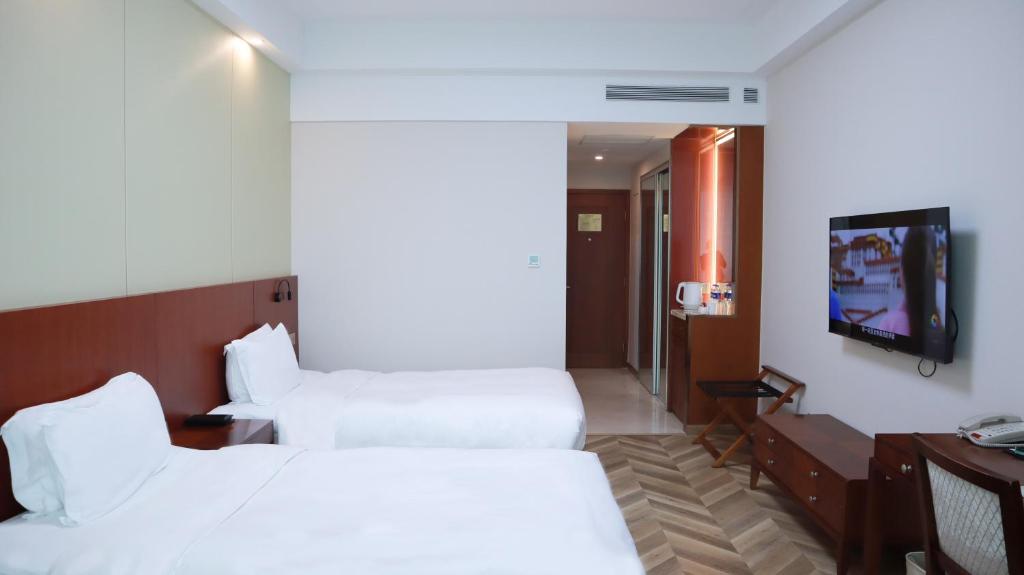 TV a/nebo společenská místnost v ubytování Shanghai Metropark Jichen Hotel