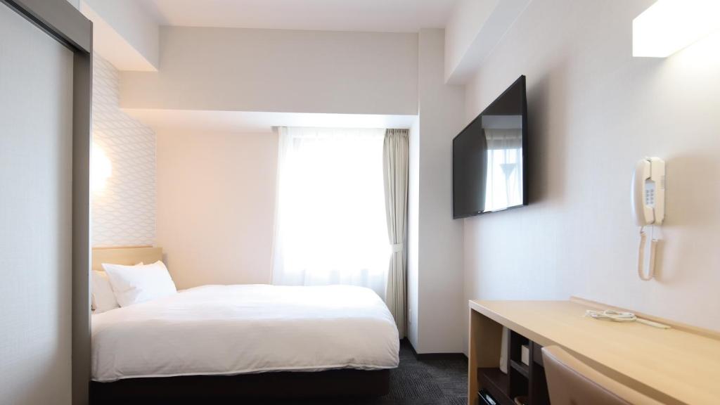 Postel nebo postele na pokoji v ubytování AB Hotel Konan