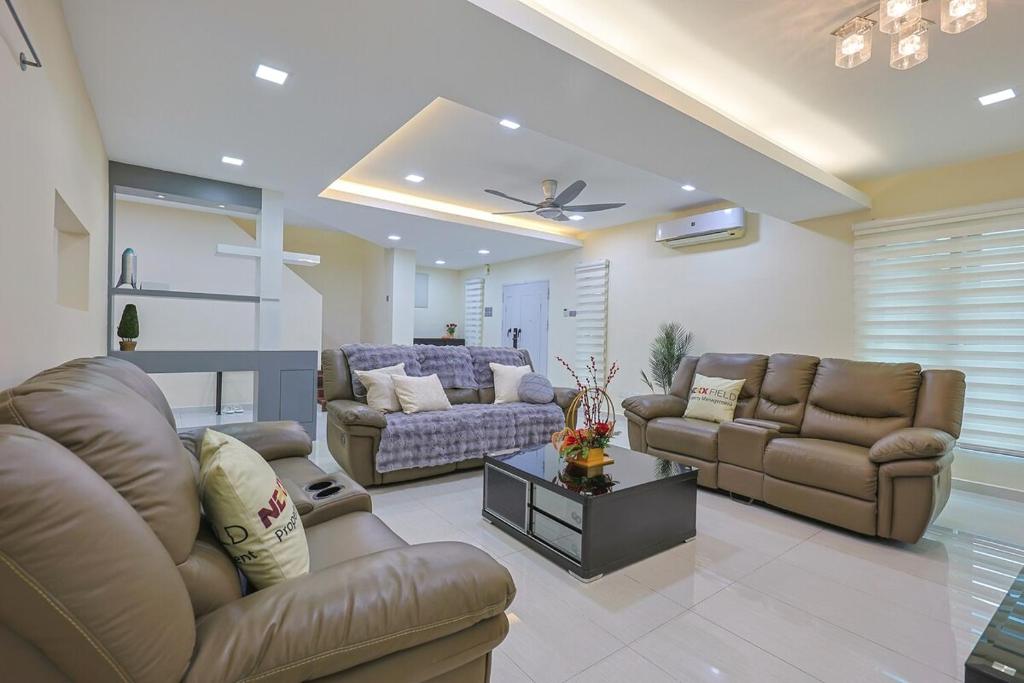 a living room with two couches and a couch at Spacious 12 pax Landed Homestay By NexxField in Ampang