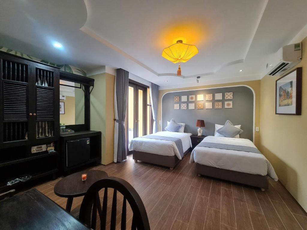 Postel nebo postele na pokoji v ubytování Hoianan Boutique Hotel