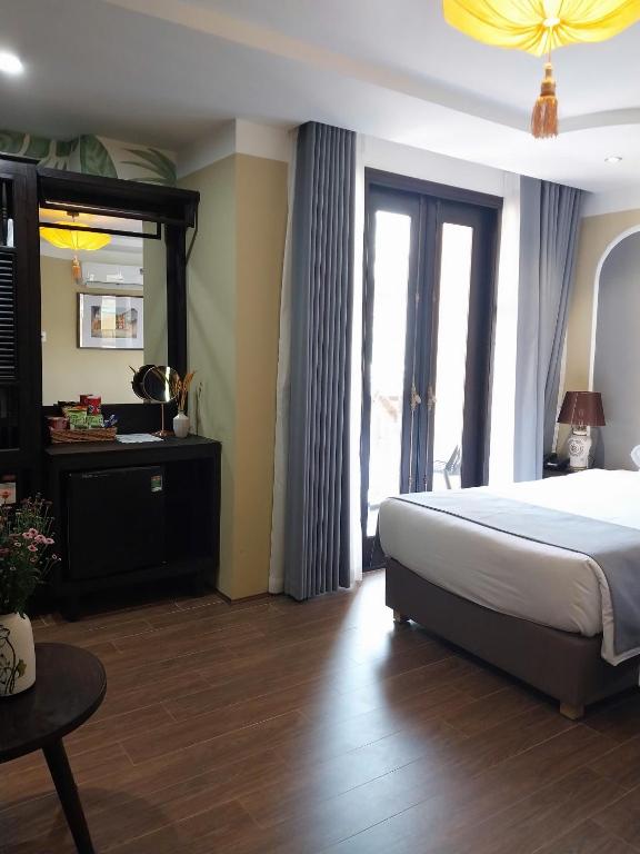 Postel nebo postele na pokoji v ubytování Hoianan Boutique Hotel