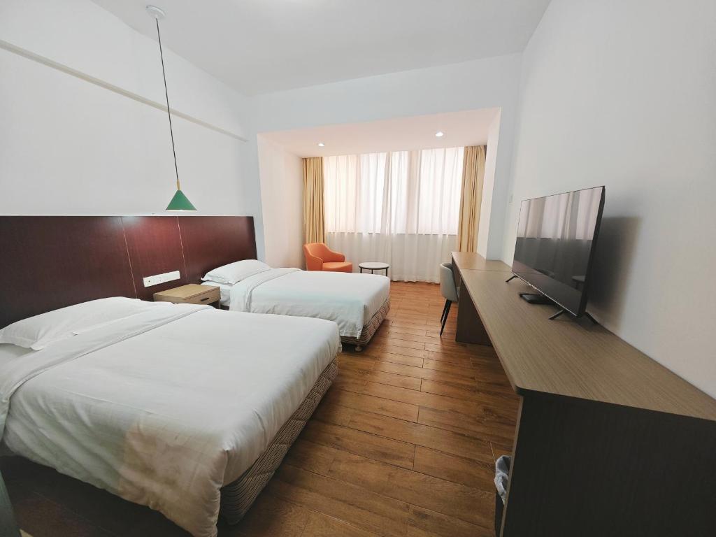 TV a/nebo společenská místnost v ubytování Shenzhen Xinghua Hotel