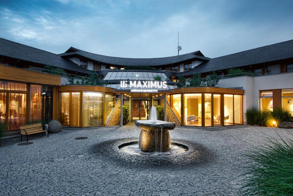 a building with a fountain in the middle of a courtyard at Maximus Resort in Brno