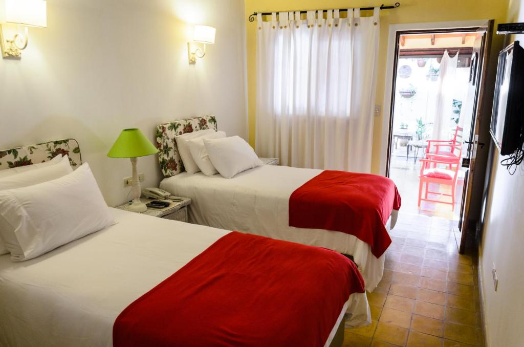 Postel nebo postele na pokoji v ubytování La Casona Hotel Boutique