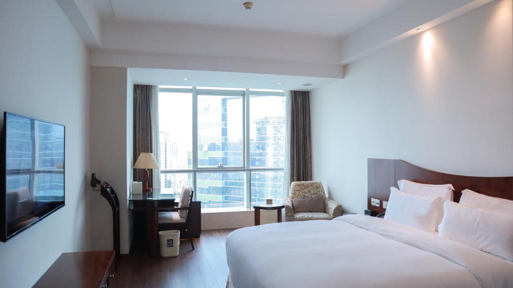 Postel nebo postele na pokoji v ubytování Shanghai Metropark Jichen Hotel