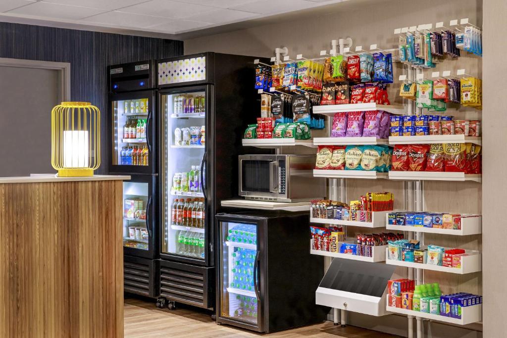 a store with an open refrigerator and lots of food at Spark by Hilton Denver International Airport in Denver