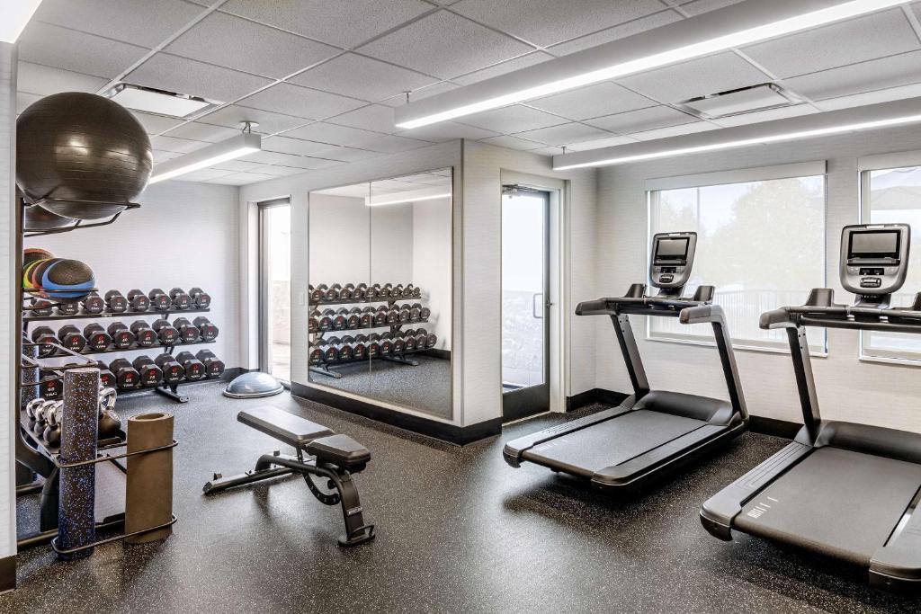 a gym with two treadmills and a mirror at Spark by Hilton Denver International Airport in Denver