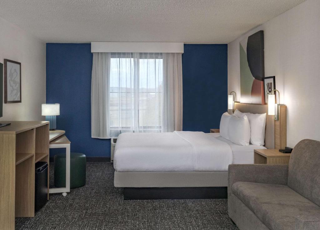 a hotel room with a large bed and a window at Spark by Hilton Denver International Airport in Denver