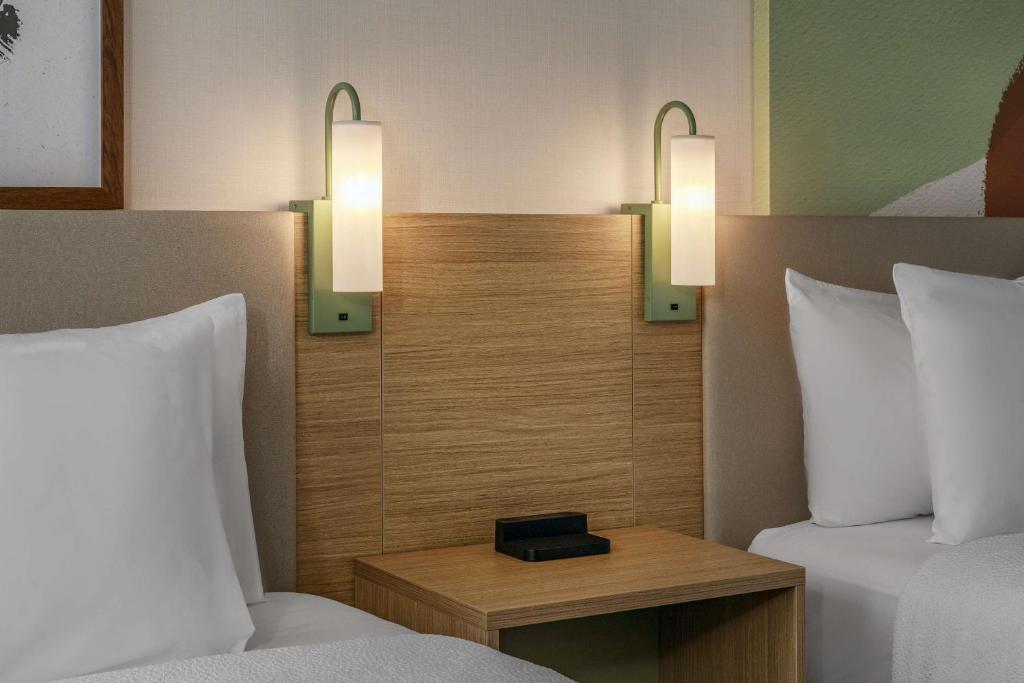a hotel room with two beds and two lights at Spark by Hilton Denver International Airport in Denver