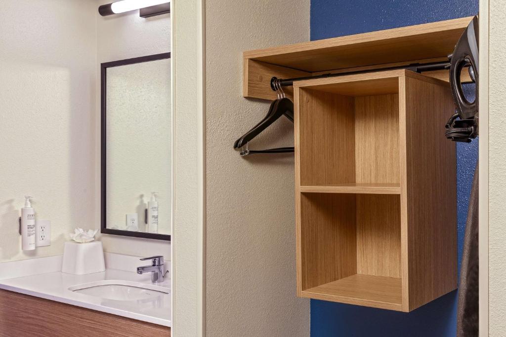 a bathroom with a sink and a mirror at Spark by Hilton Denver International Airport in Denver