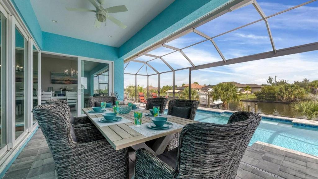 a dining room with a table and chairs and a pool at Luxury Contemporary Style House on Charlotte Harbor Area Charlotte County House 5841 in Placida