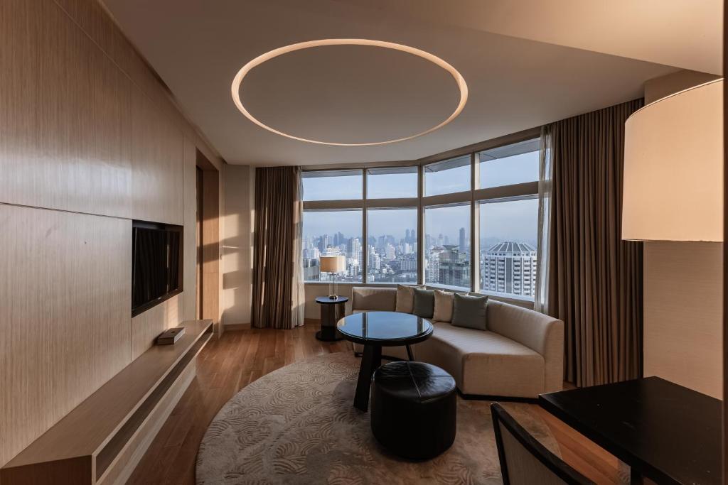 a living room with a couch and a table at Bangkok Marriott Hotel Sukhumvit in Bangkok