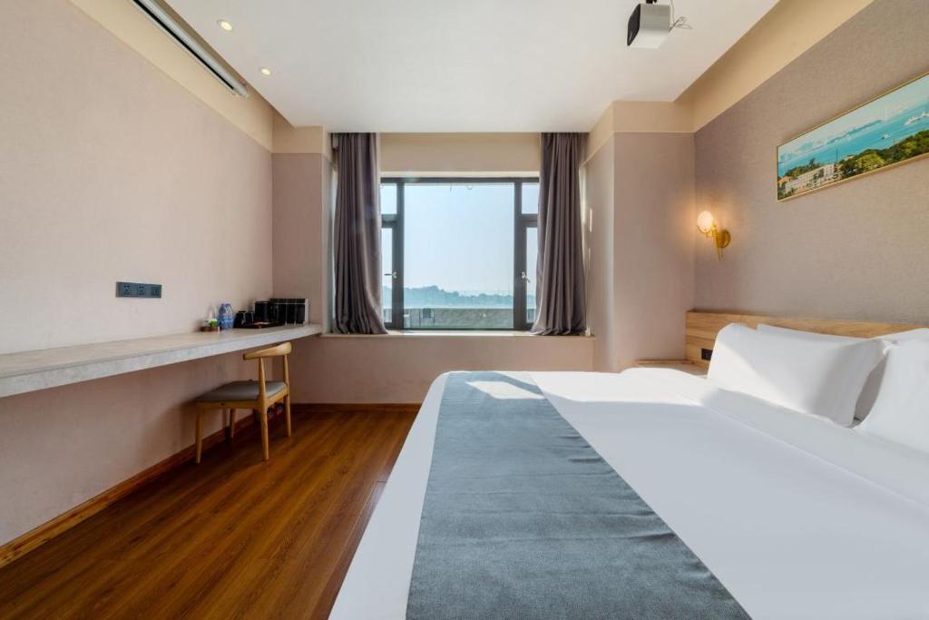 Postel nebo postele na pokoji v ubytování 厦门中山海滨酒店