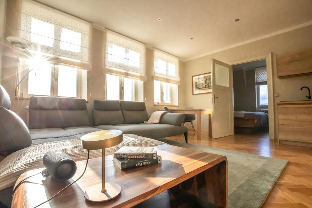 a living room with a couch and a table at Husova 87 Rosewood Suite in Liberec