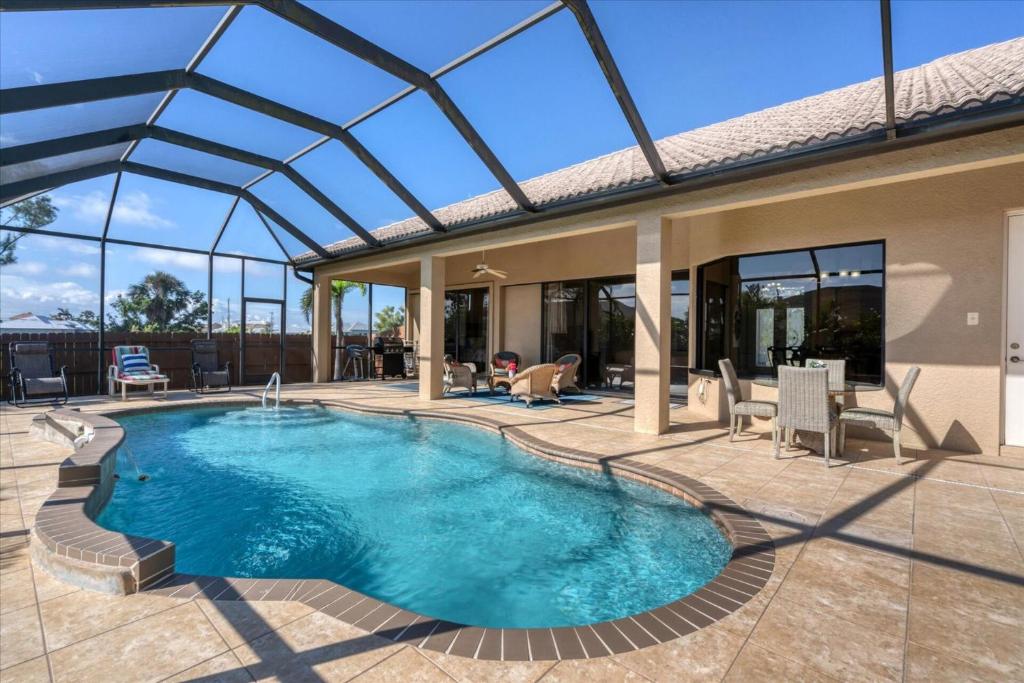 a swimming pool in a house with a glass roof at Cape Coral Villa 1001: Private Pool Tranquil Stay in Matlacha