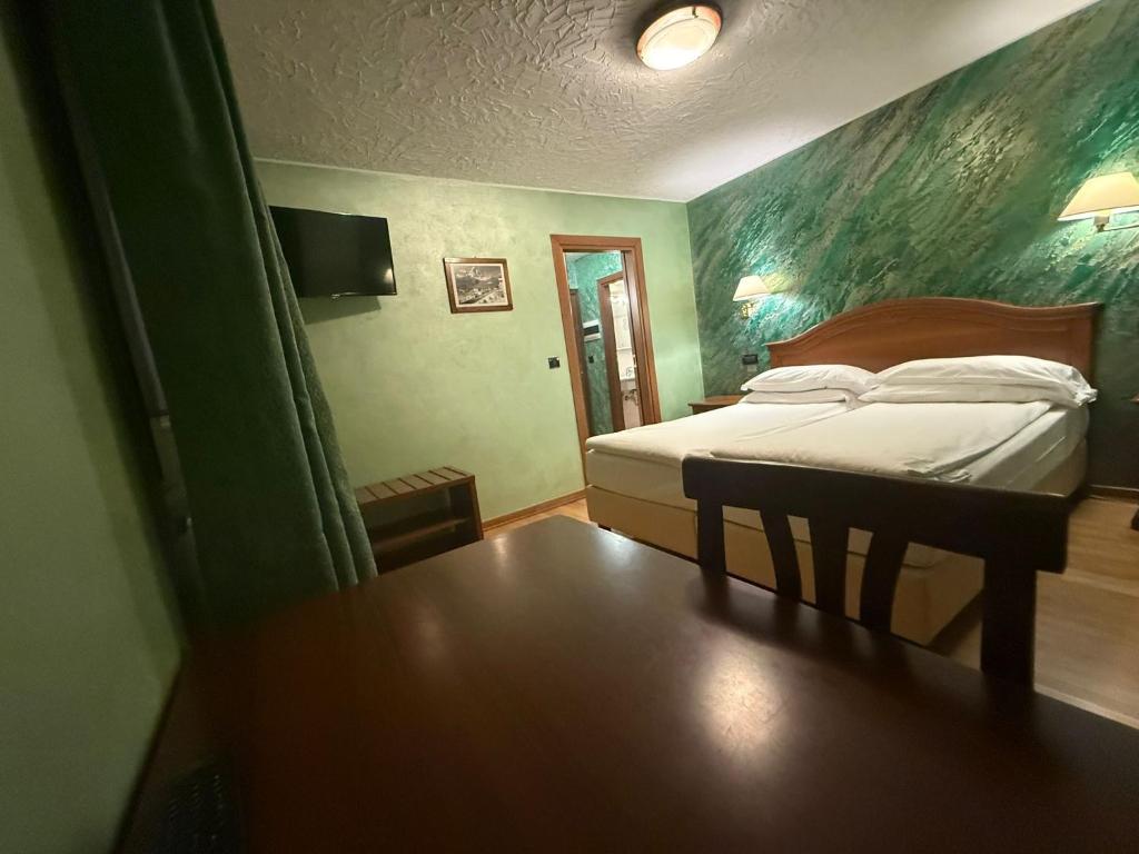 Postel nebo postele na pokoji v ubytování Hotel Breuil