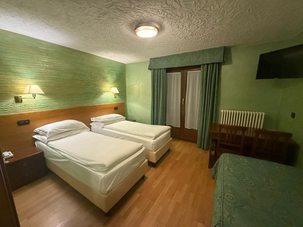 Postel nebo postele na pokoji v ubytování Hotel Breuil