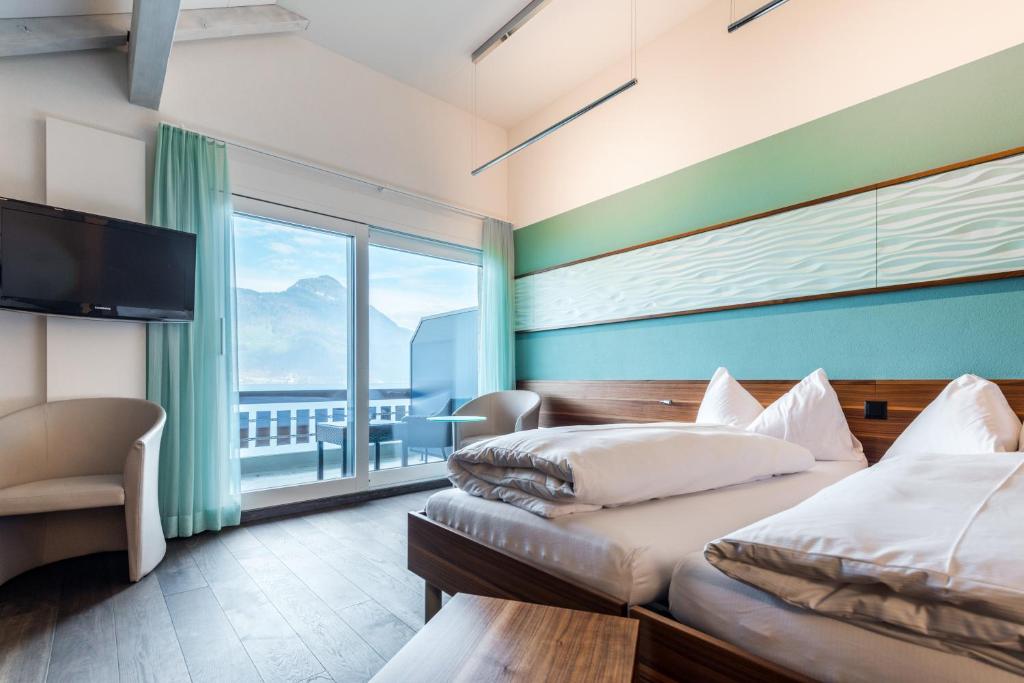Postel nebo postele na pokoji v ubytování Superior Hotel Nidwaldnerhof