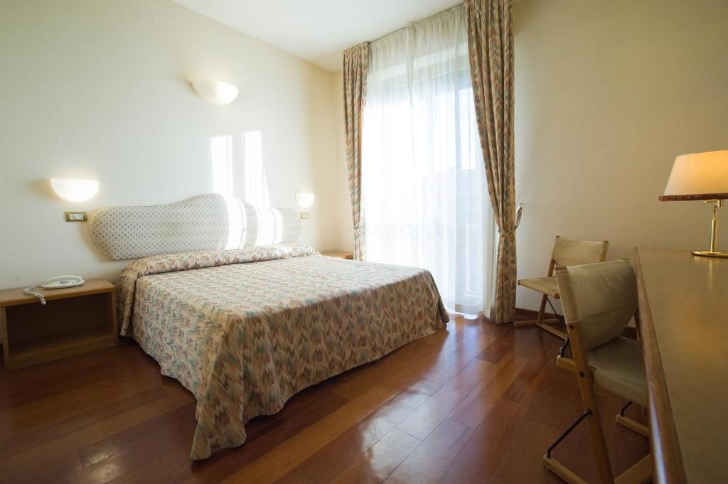Postel nebo postele na pokoji v ubytování Hotel Villa Ricci & Benessere
