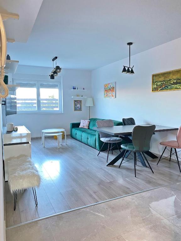 a living room with a green couch and a table at Bubble in Trogir