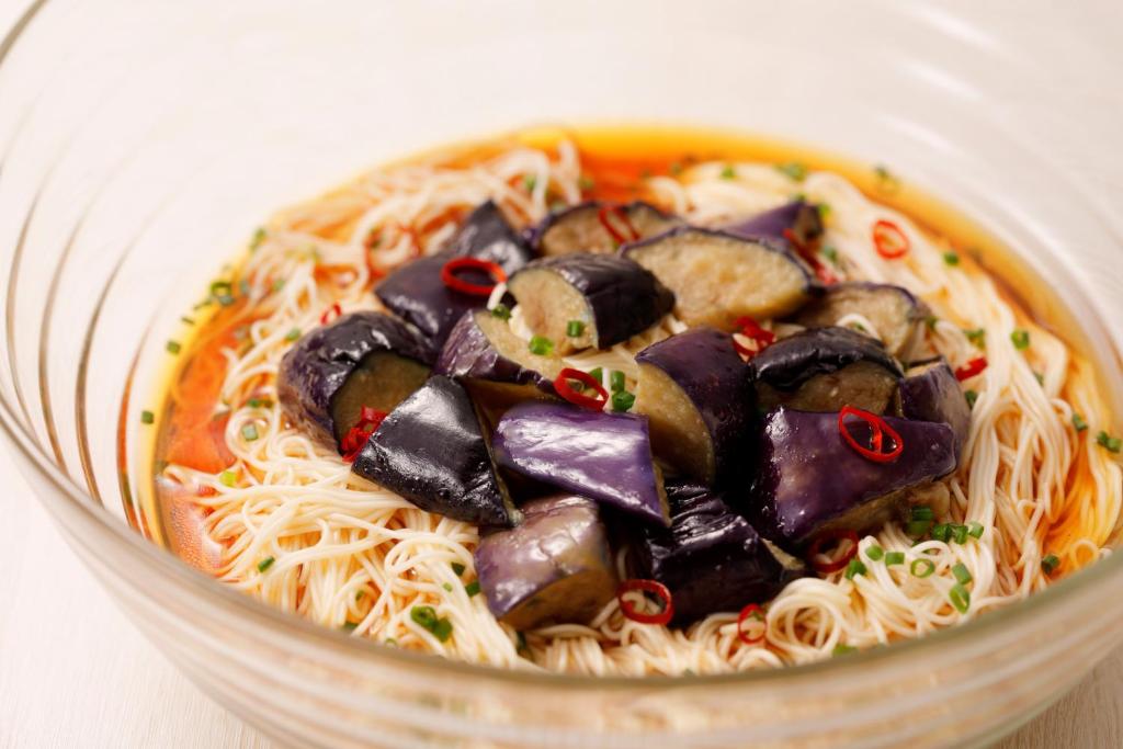 a bowl of noodles with meat and vegetables on it at HOTEL MYSTAYS Kanazawa Castle in Kanazawa