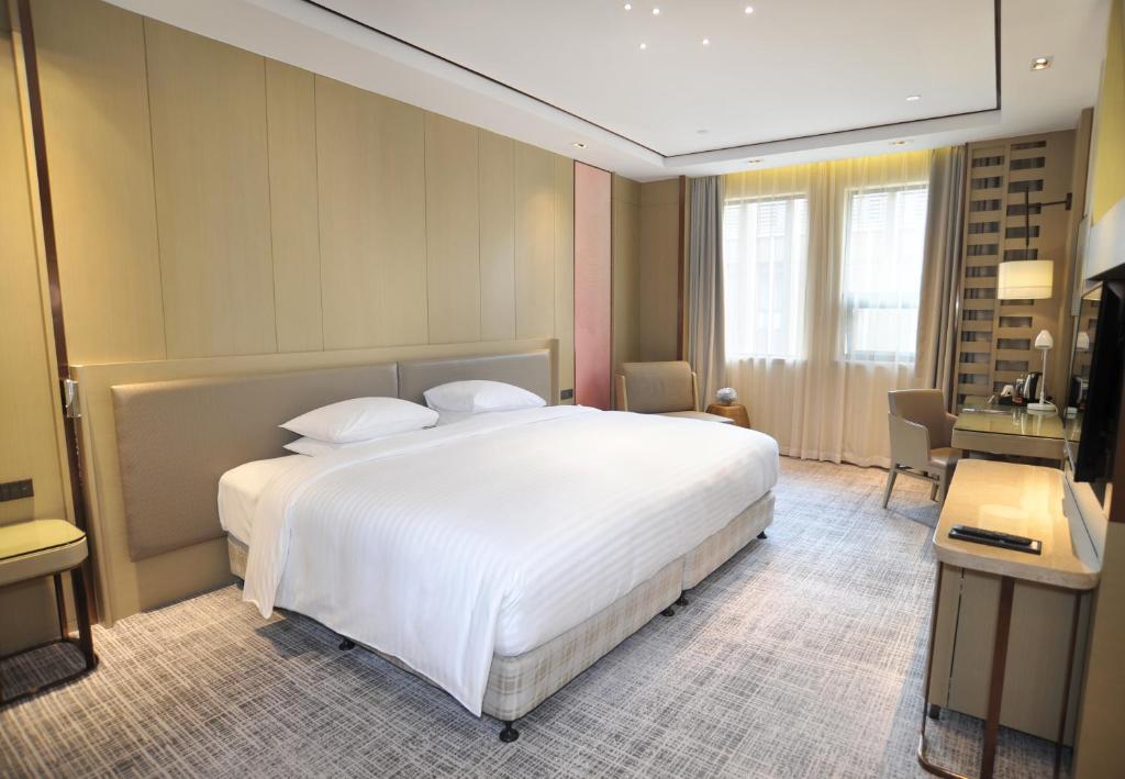 Postel nebo postele na pokoji v ubytování Courtyard by Marriott Shanghai International Tourism and Resorts Zone