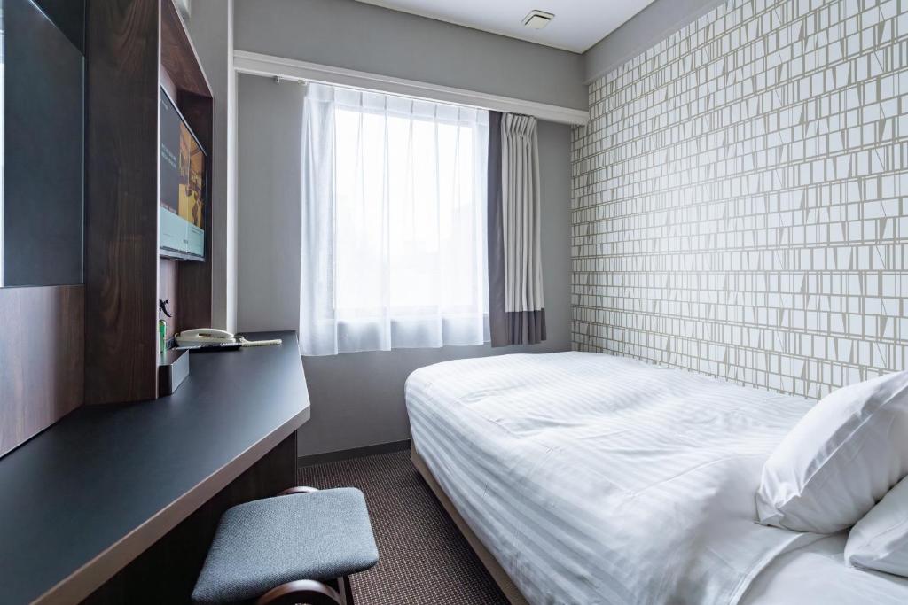 Postel nebo postele na pokoji v ubytování Hotel Odashima