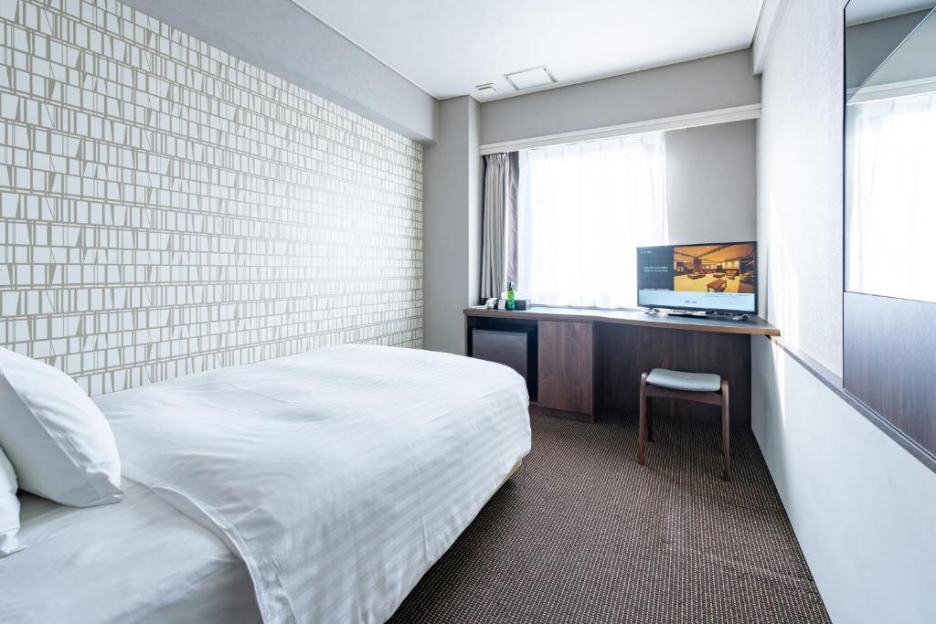Postel nebo postele na pokoji v ubytování Hotel Odashima