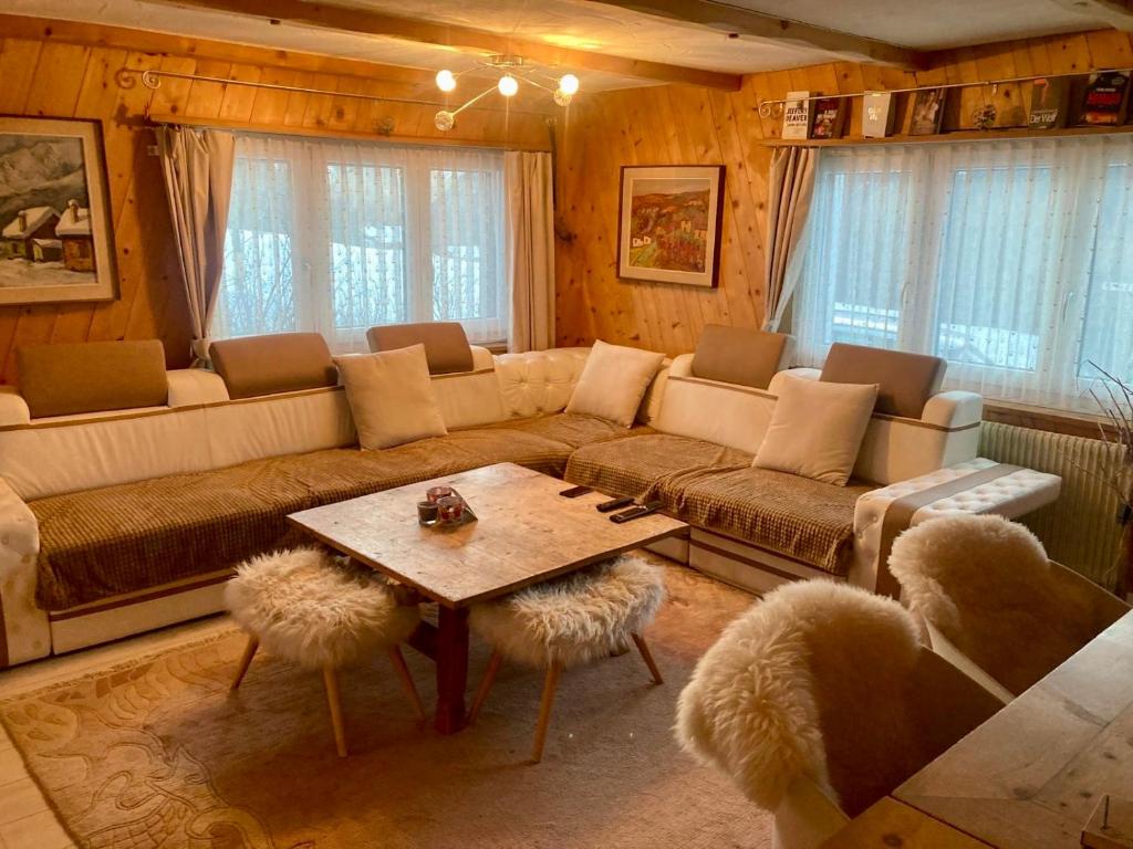 a living room with a couch and a table at Ski Chalet Rinerhorn in Glaris