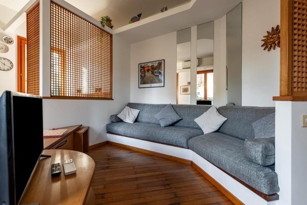 a living room with a couch and a tv at Cozy 2-Bedroom Stay at Lido di Venezia in Lido
