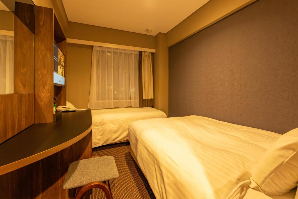 Postel nebo postele na pokoji v ubytování Hotel Odashima