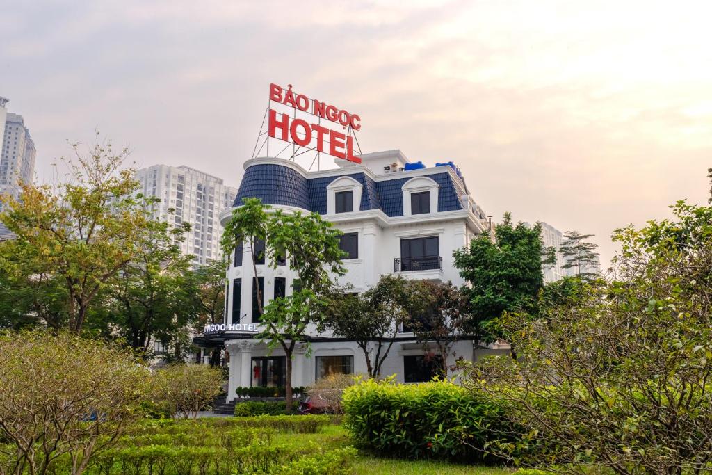 a white house hotel with a sign on top of it at Bao Ngọc Hotel Dương Nội in Hanoi