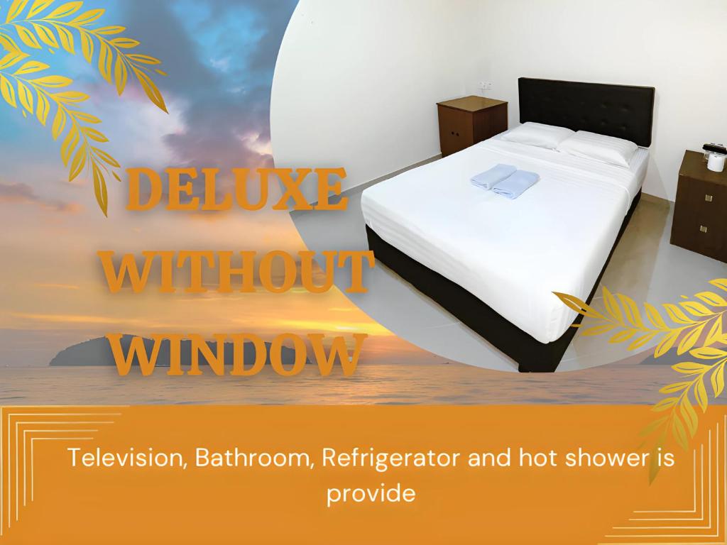 a bed in a room with a window with at Amzar Motel Cenang in Pantai Cenang