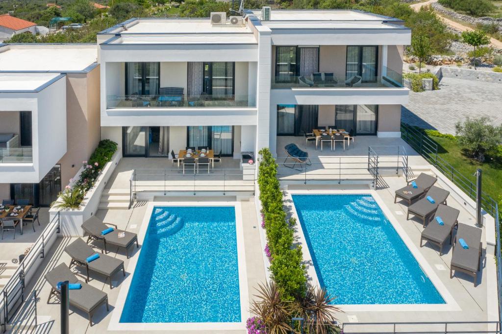 an aerial view of a villa with two swimming pools at Villa Lemon Tree in Vinišće