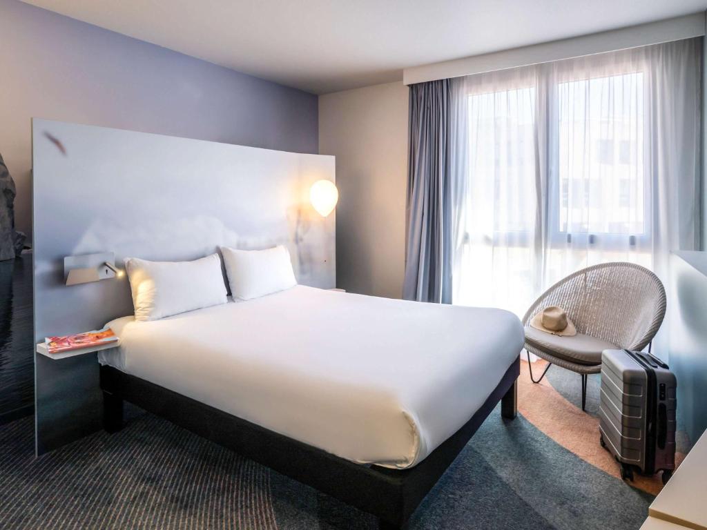 a hotel room with a large bed and a window at ibis Styles Toulon Centre Port in Toulon