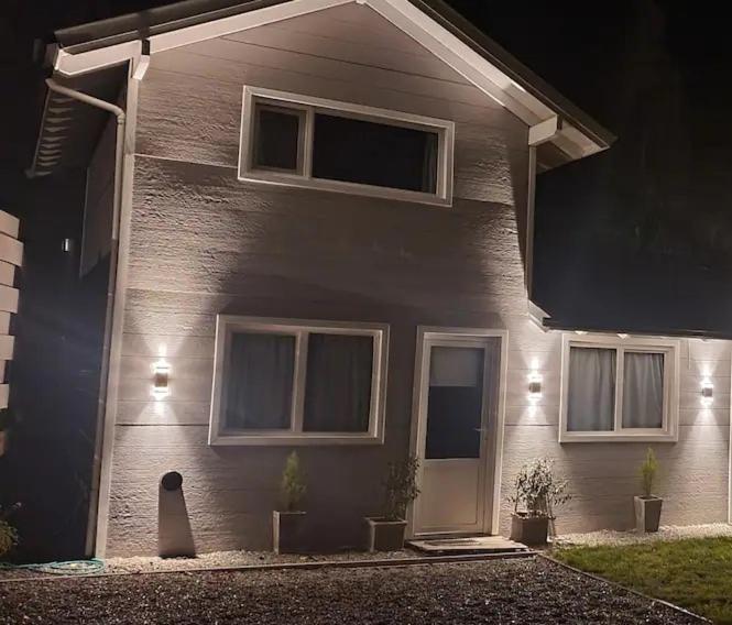 a house with a dog sitting in front of it at Don Filoteo in Villa La Angostura