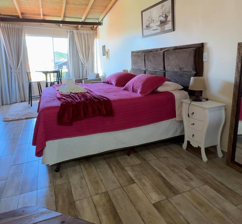 En eller flere senge i et værelse på Pousada Vista ao Farol